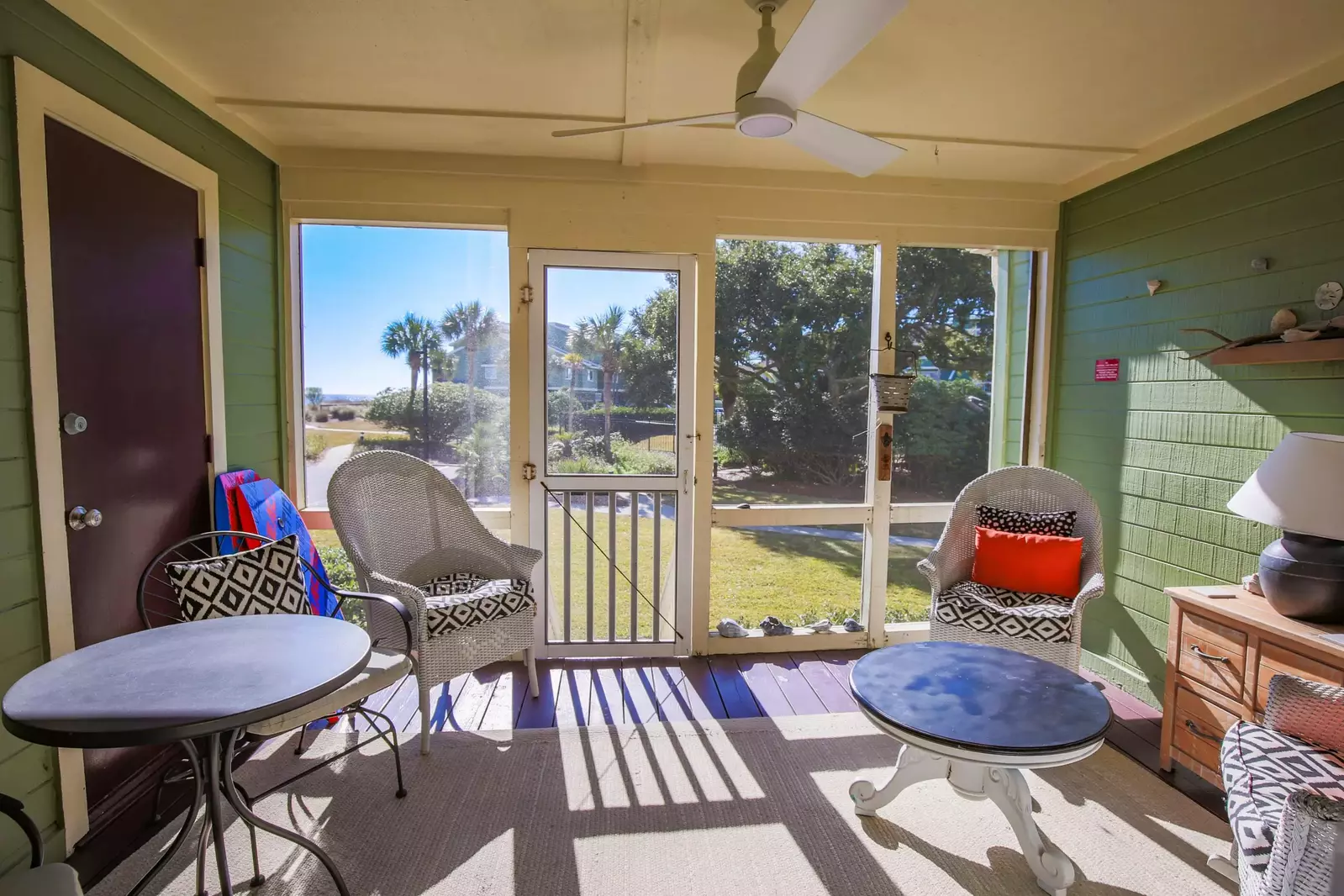 This door on the screened porch leads you to the community pool, grill area and beach access point.