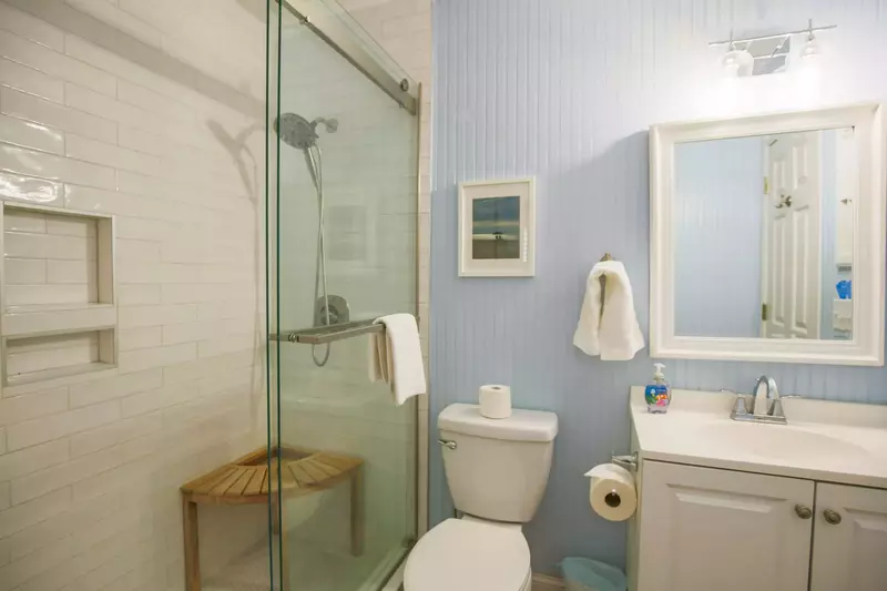 This full bathroom is accessible through the bedroom and through the hall at the top of the stairs.