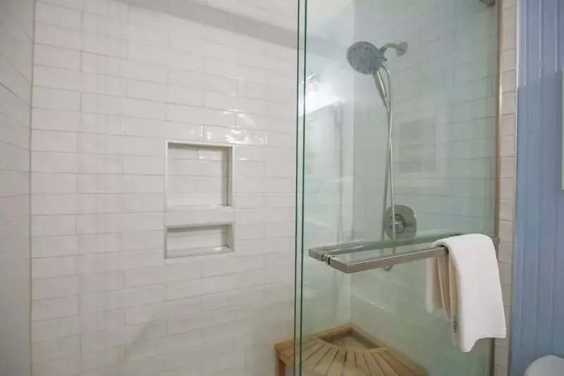 The en suite bathroom features a new, beautifully tiled shower.