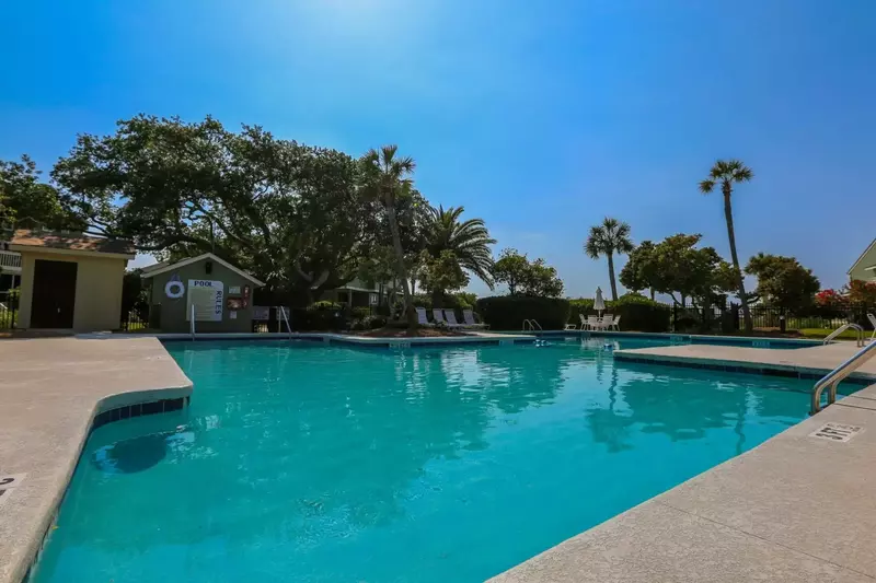 The Mariners Walk community pool has lounge chairs, a dining table and multiple entry points.
