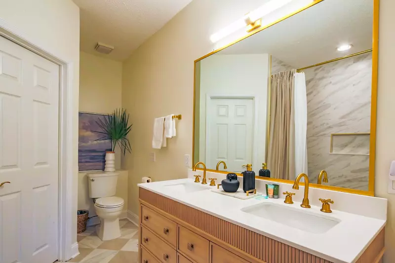 The en suite bathroom features a new double sink vanity and a new mirror.