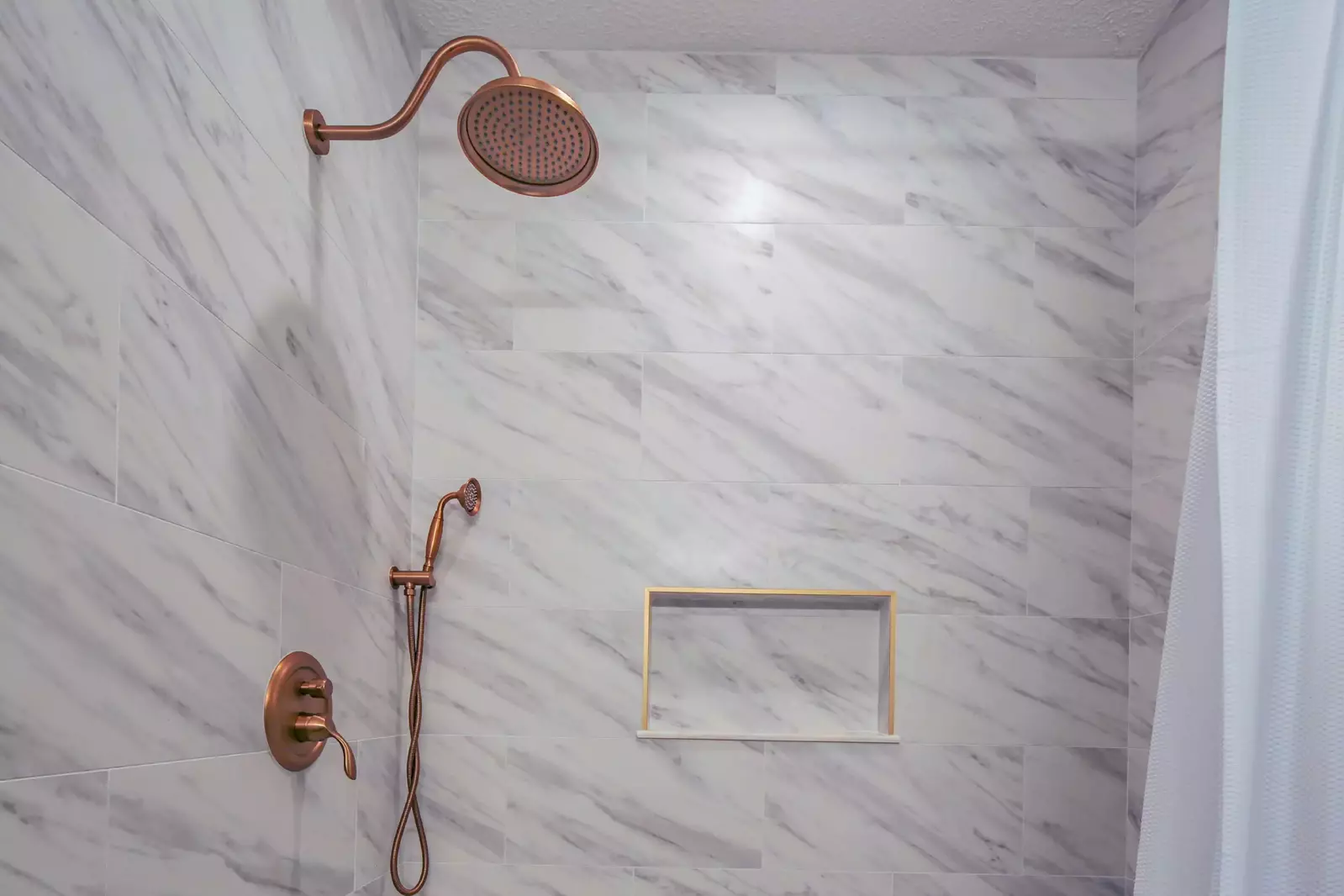 The master bathroom also features a beautifully tiled, walk-in shower.
