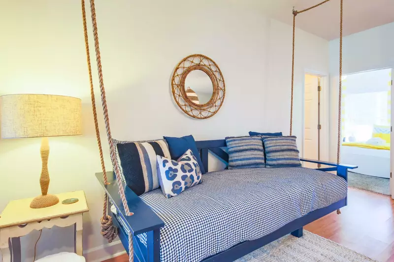 The hallway bathroom and the guest bedroom are located on the right side of the swing bed.