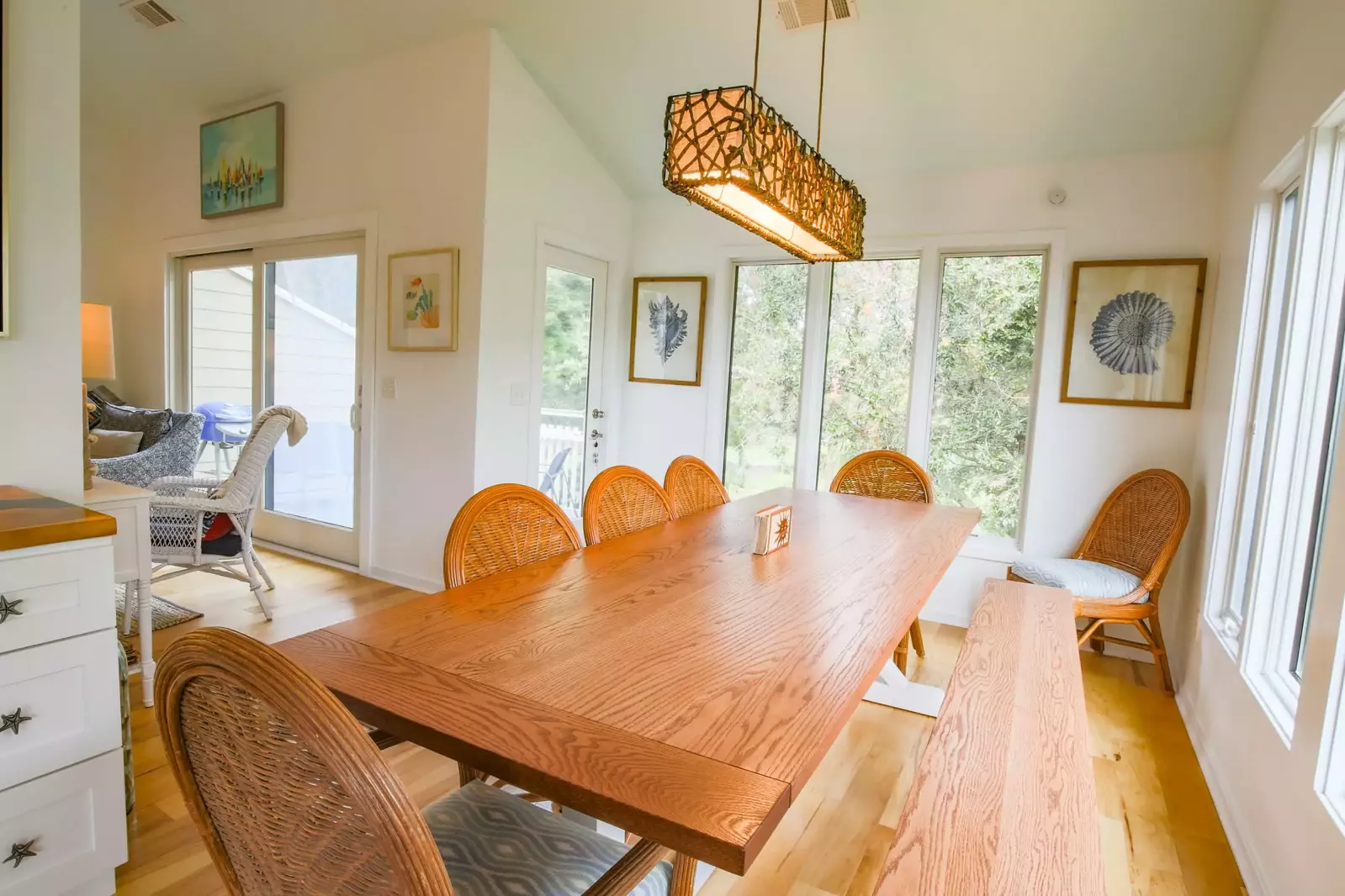 The dining table seats 8 people and there are 4 stools at the kitchen counter.