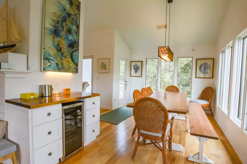 There is a beverage refrigerator and useable counter space or bar near the dining table.