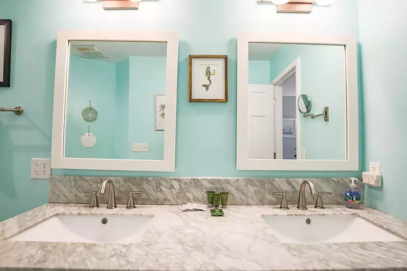 The en suite bath features a double sink vanity.