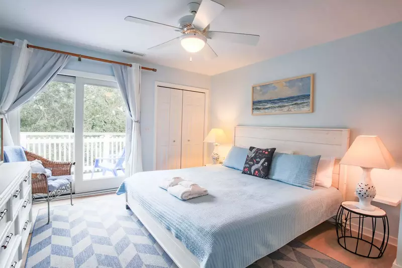 This guest bedroom features a king bed and night stands with reading lamps.