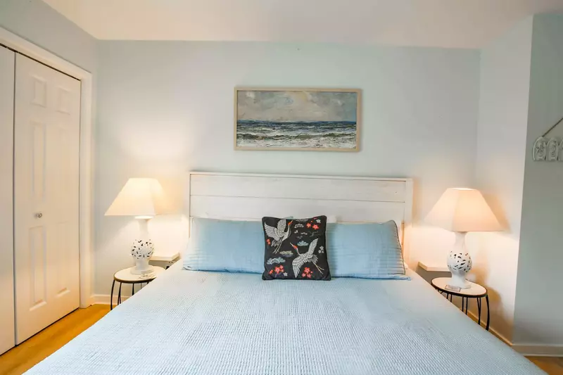 The guest bedroom is decorated with a soothing mix of coastal colors.
