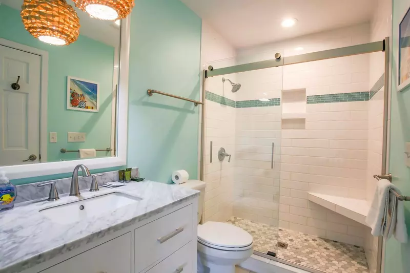 This beautifully renovated bathroom features spacious vanity and a tiled, walk-in shower.