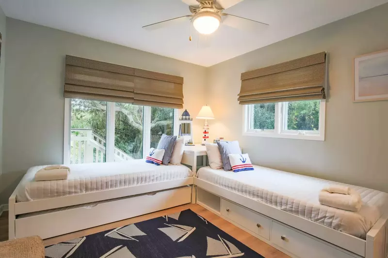 The third bedroom features two twin beds and lovely natural light.