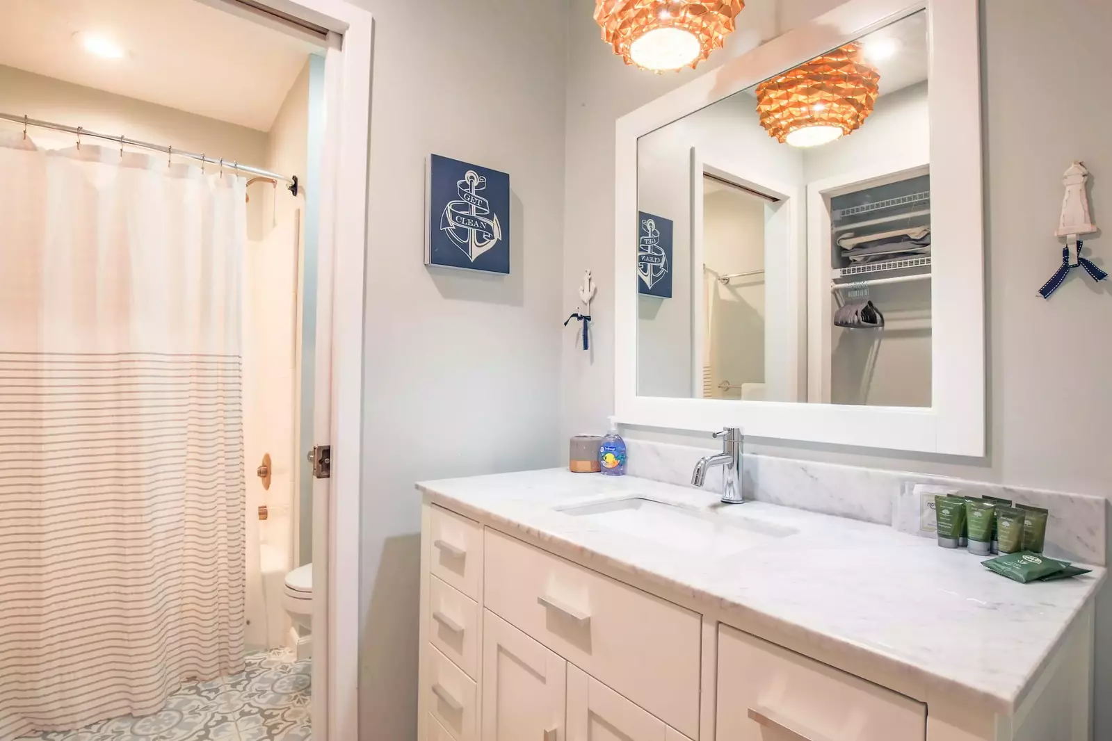 The nautical bedroom has an en suite bathroom with spacious vanity and a shower/tub combo.