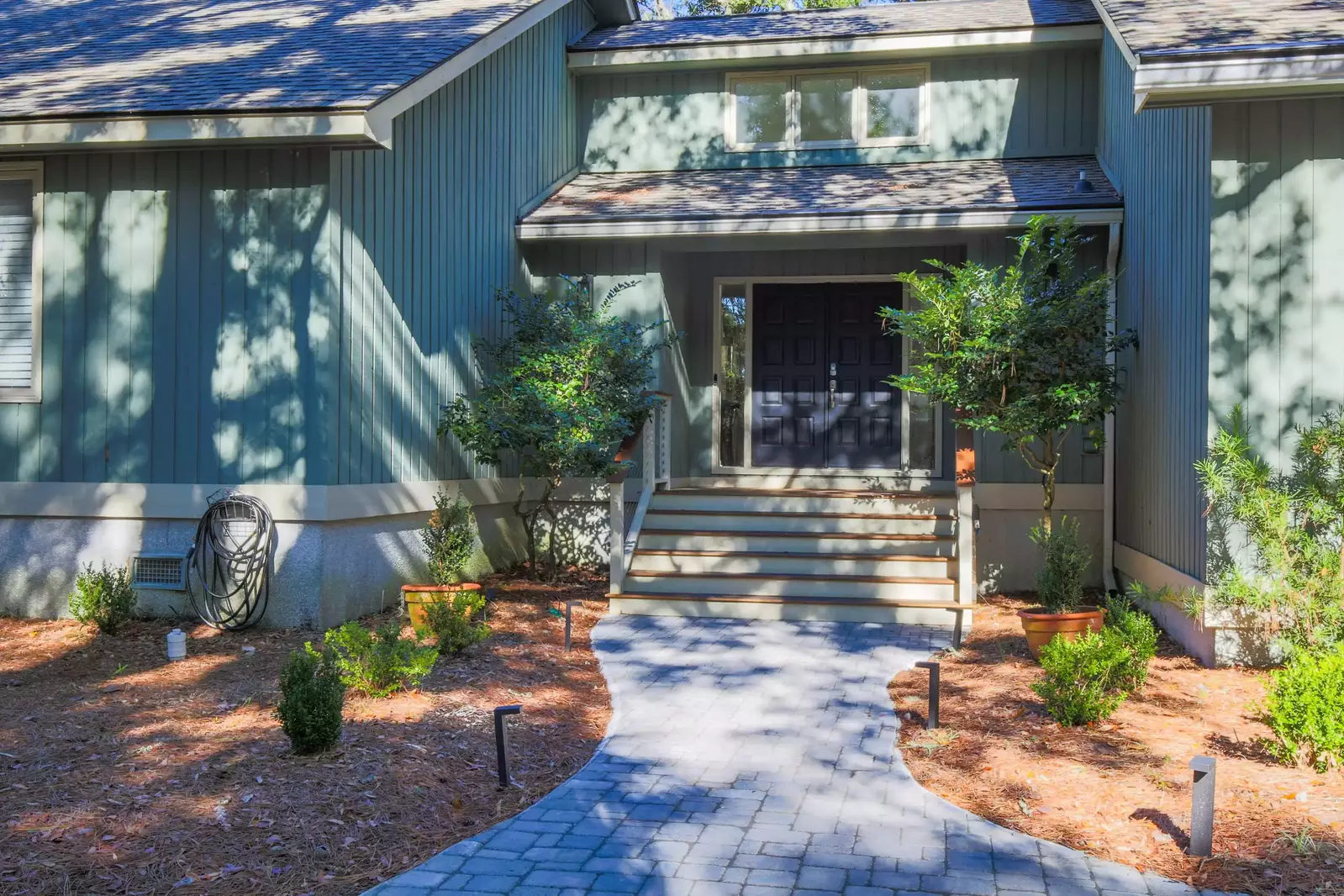 Follow the sidewalk from the driveway to the home's front door.