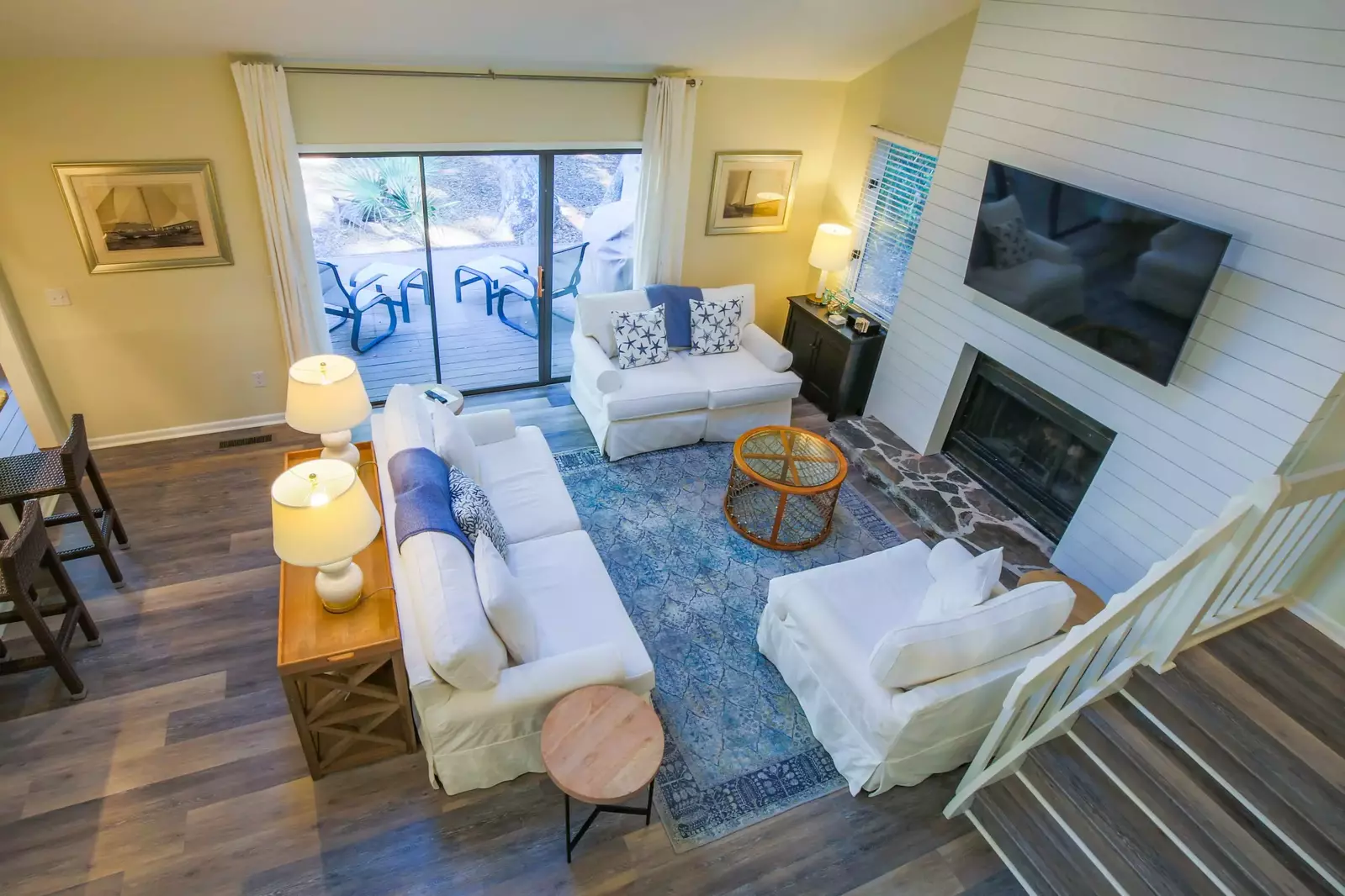 When you enter the home, you'll find this charming living room with a mounted TV and coastal colors.
