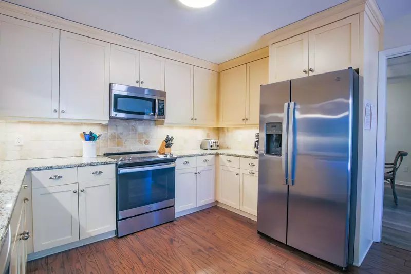 The kitchen features stainless steel appliances, granite countertops and new cabinets.