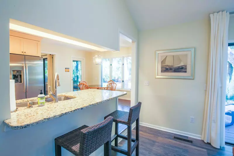 There are two high top stools near the kitchen counter.