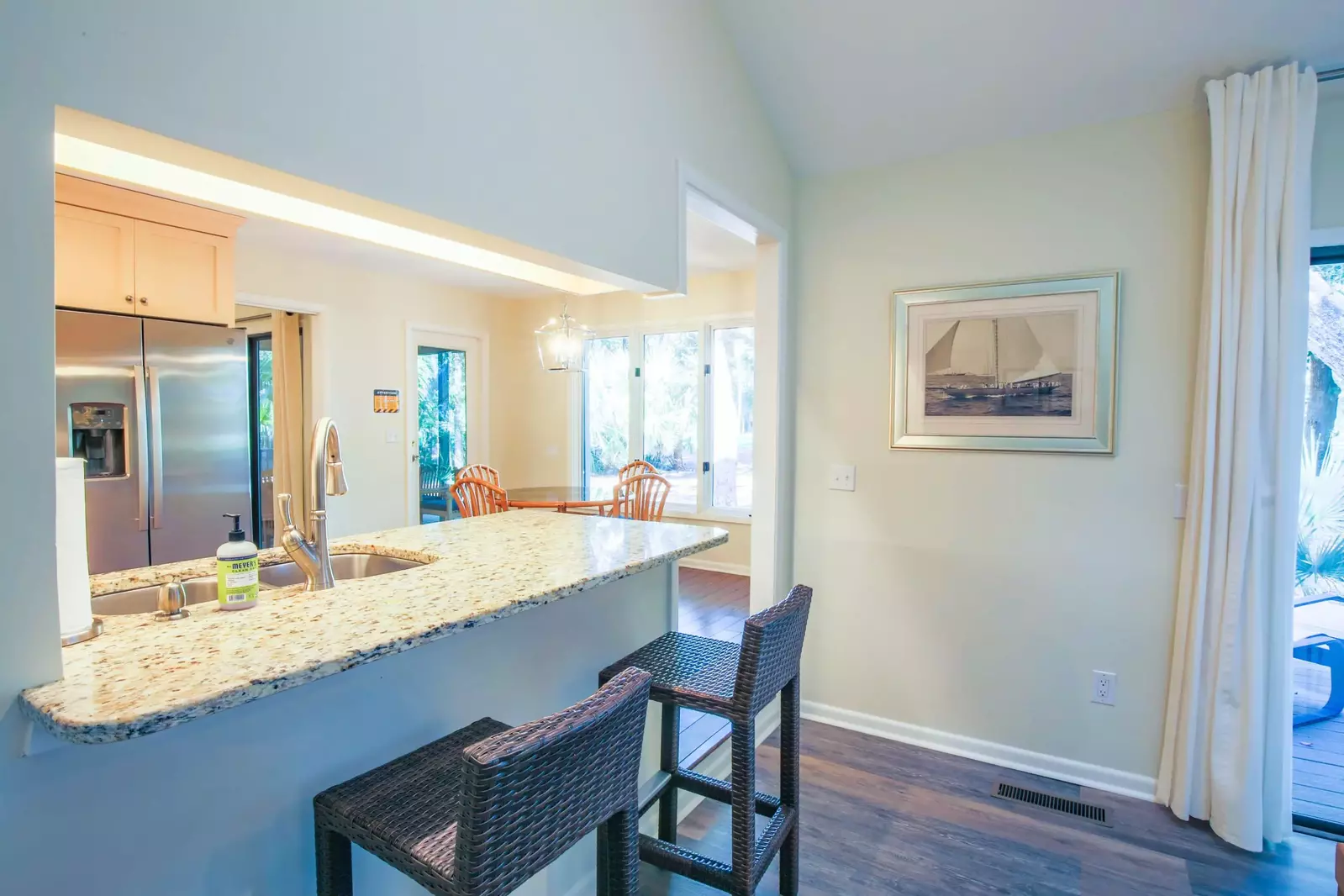There are two high top stools near the kitchen counter.