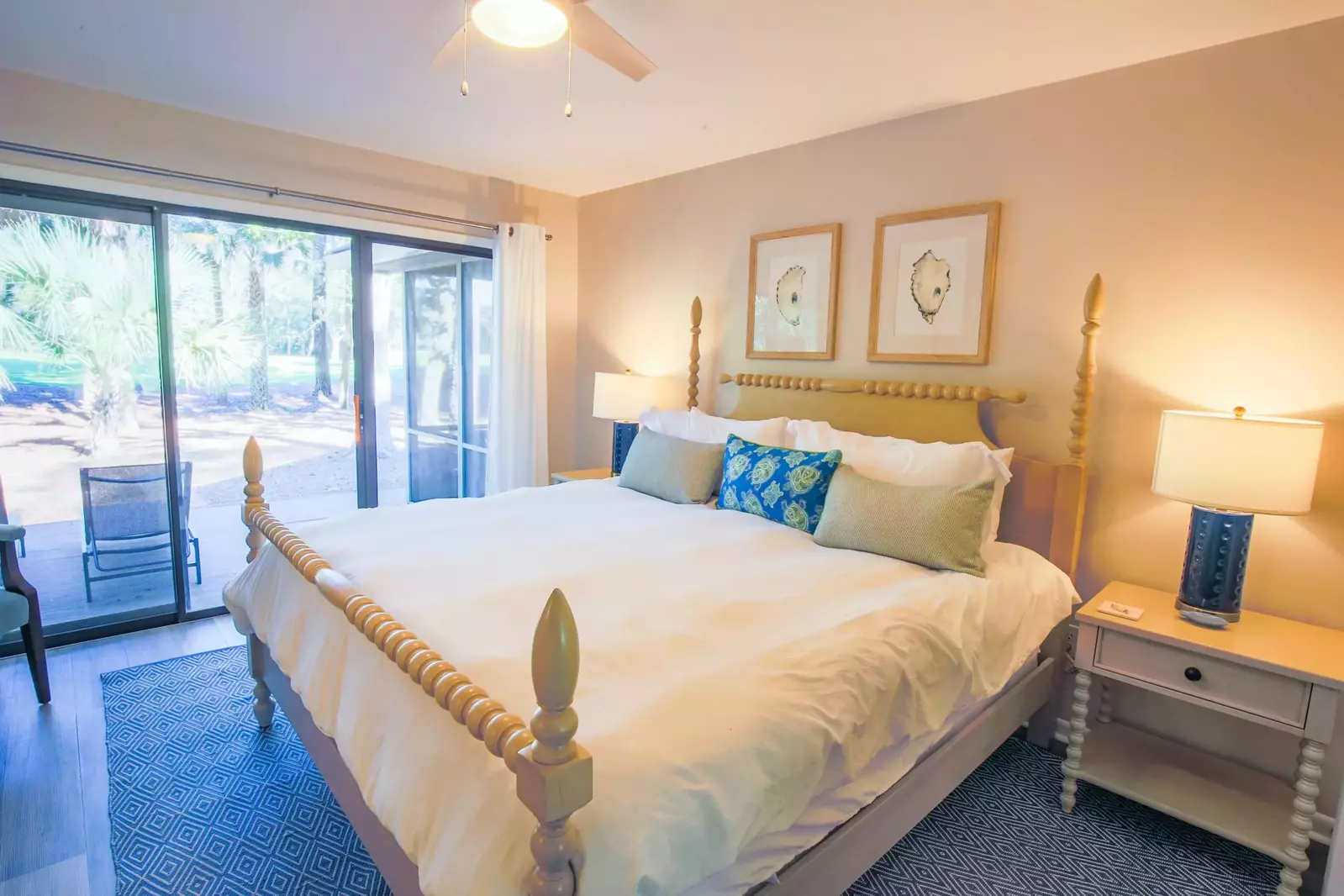 The master suite features a king bed, night stands with reading lamps and access to the back porch.