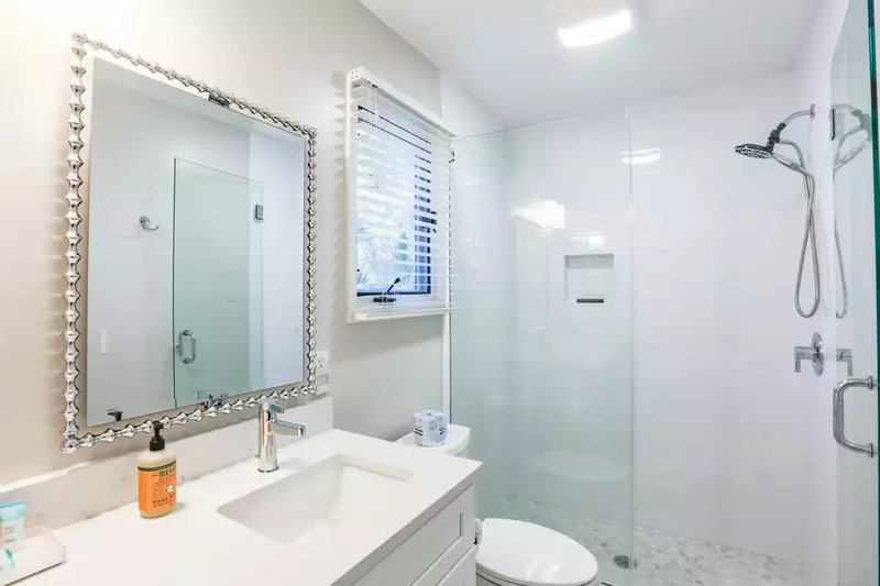 The master suite has a newly tiled walk-in shower combo and spacious, double-sink vanity.