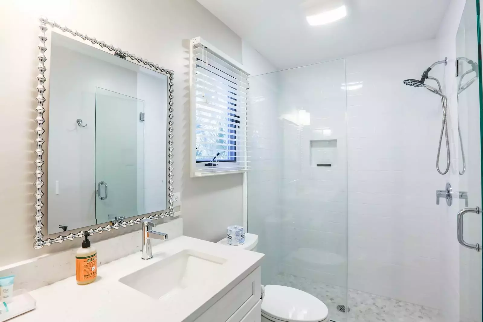 The master suite has a newly tiled walk-in shower combo and spacious, double-sink vanity.