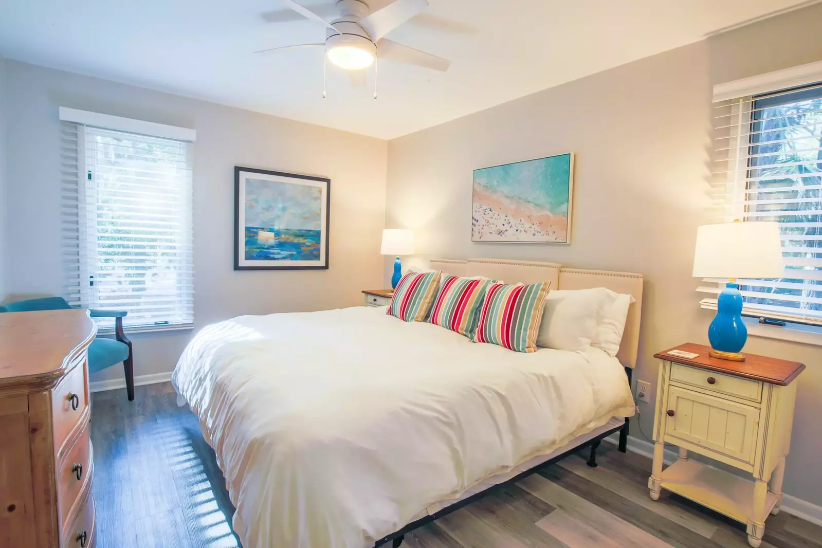 The second master suite features a king bed and two night stands with reading lamps.