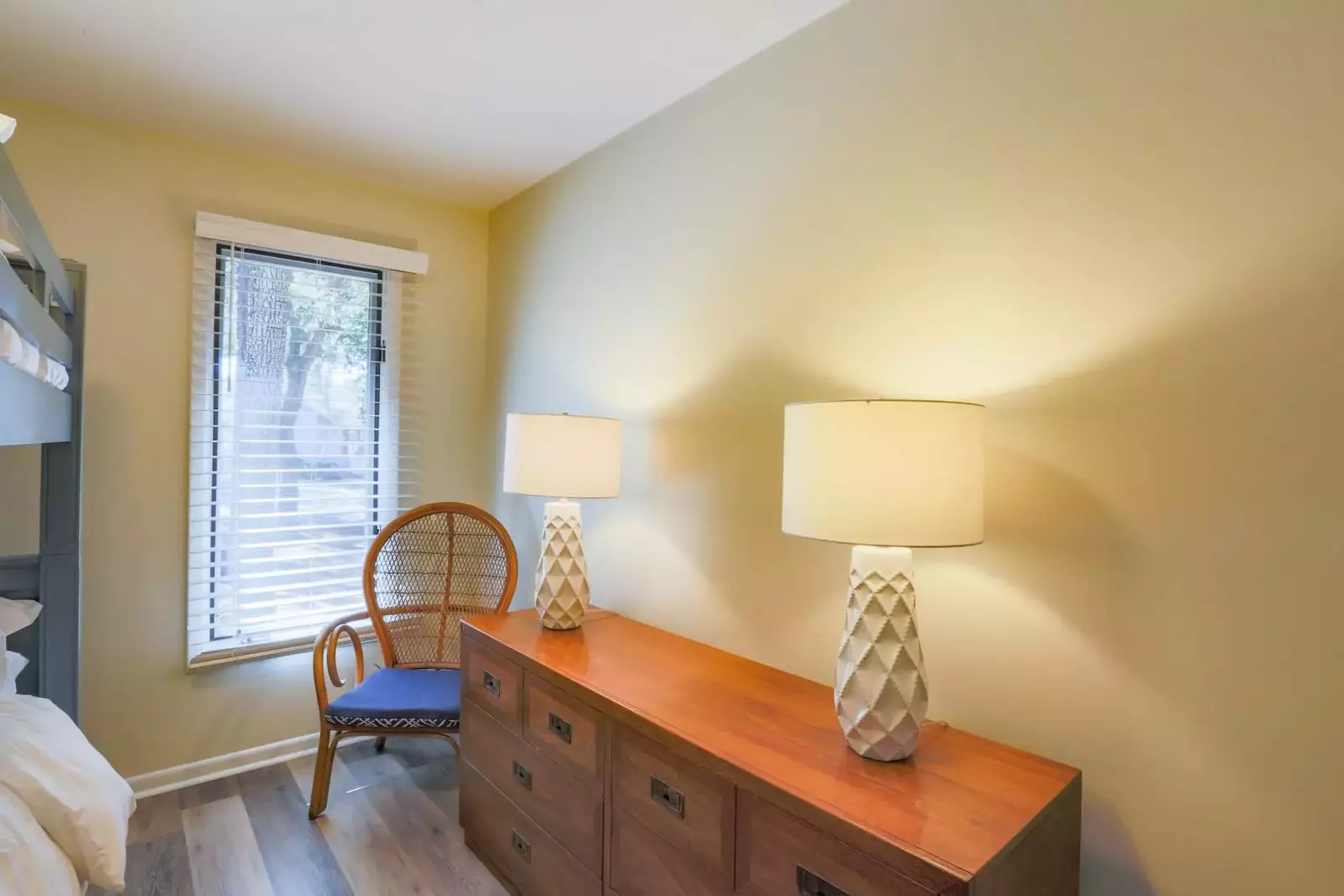 There is a also a dresser, two lamps and chair in the bunk bedroom.