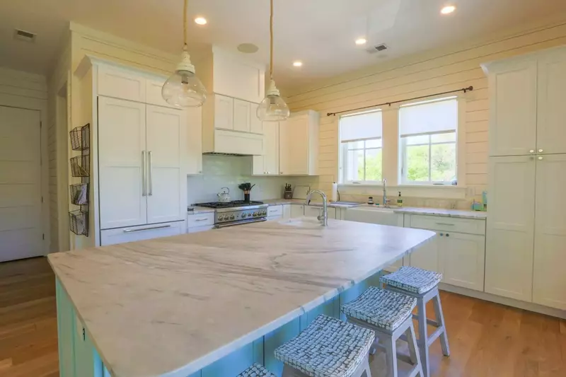The gorgeous kitchen has a Thermador six-burner pro gas range and custom built-in Thermador refrigerator.