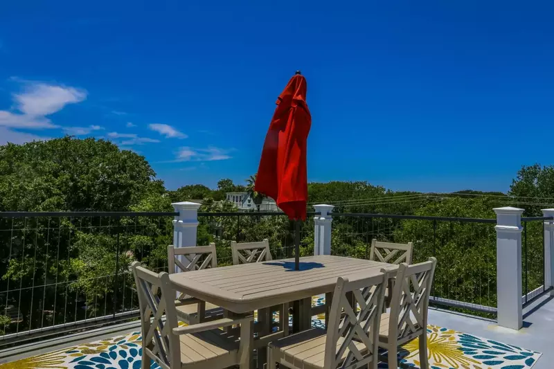 The third floor roof deck has an outdoor dining table that seats 6.