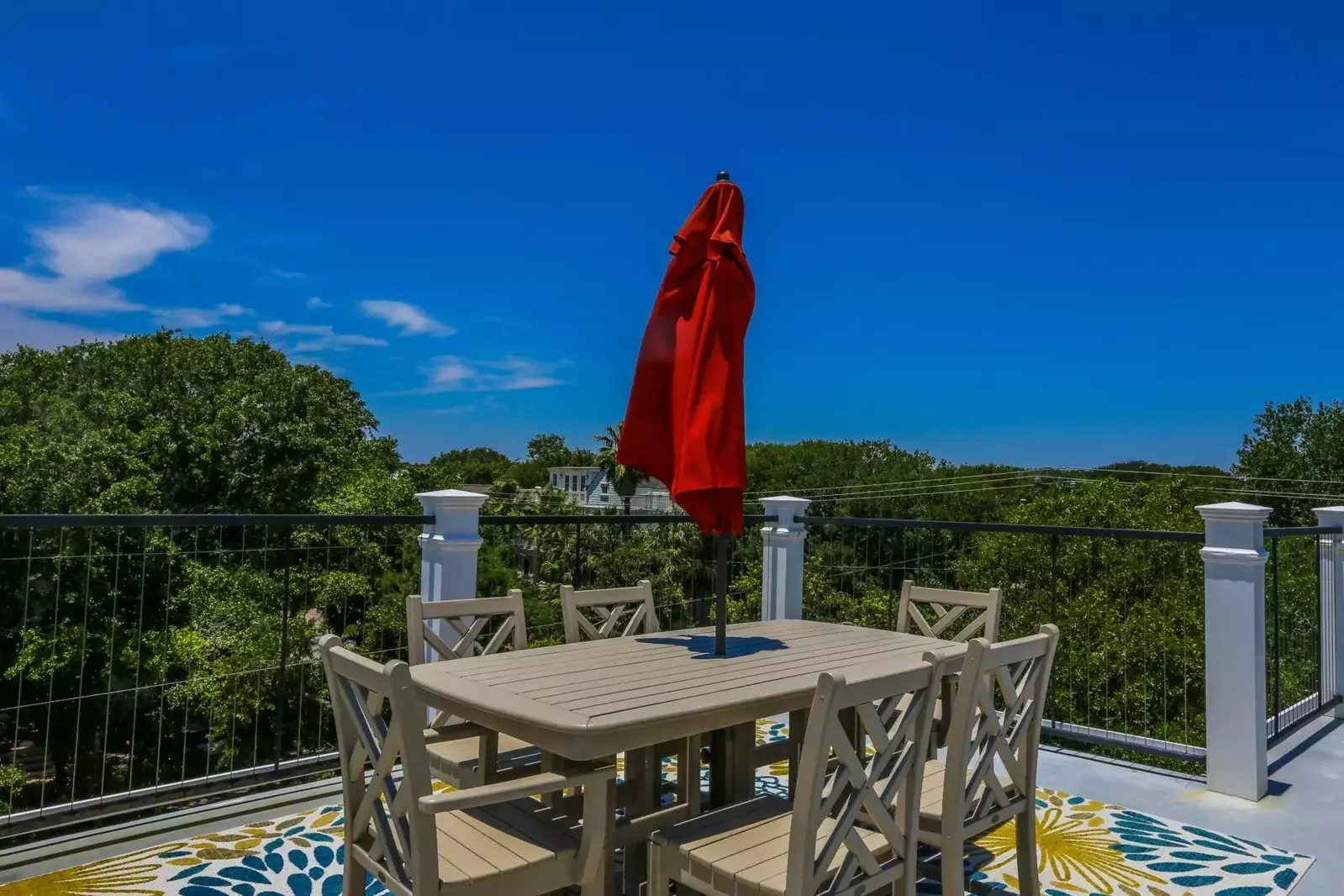 The third floor roof deck has an outdoor dining table that seats 6.