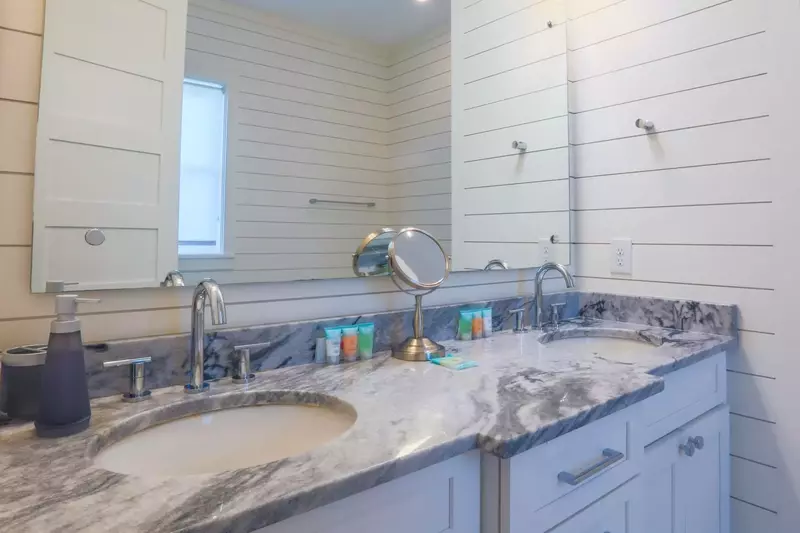 The en suite bathroom for the master suite has a spacious vanity with his & her sinks.
