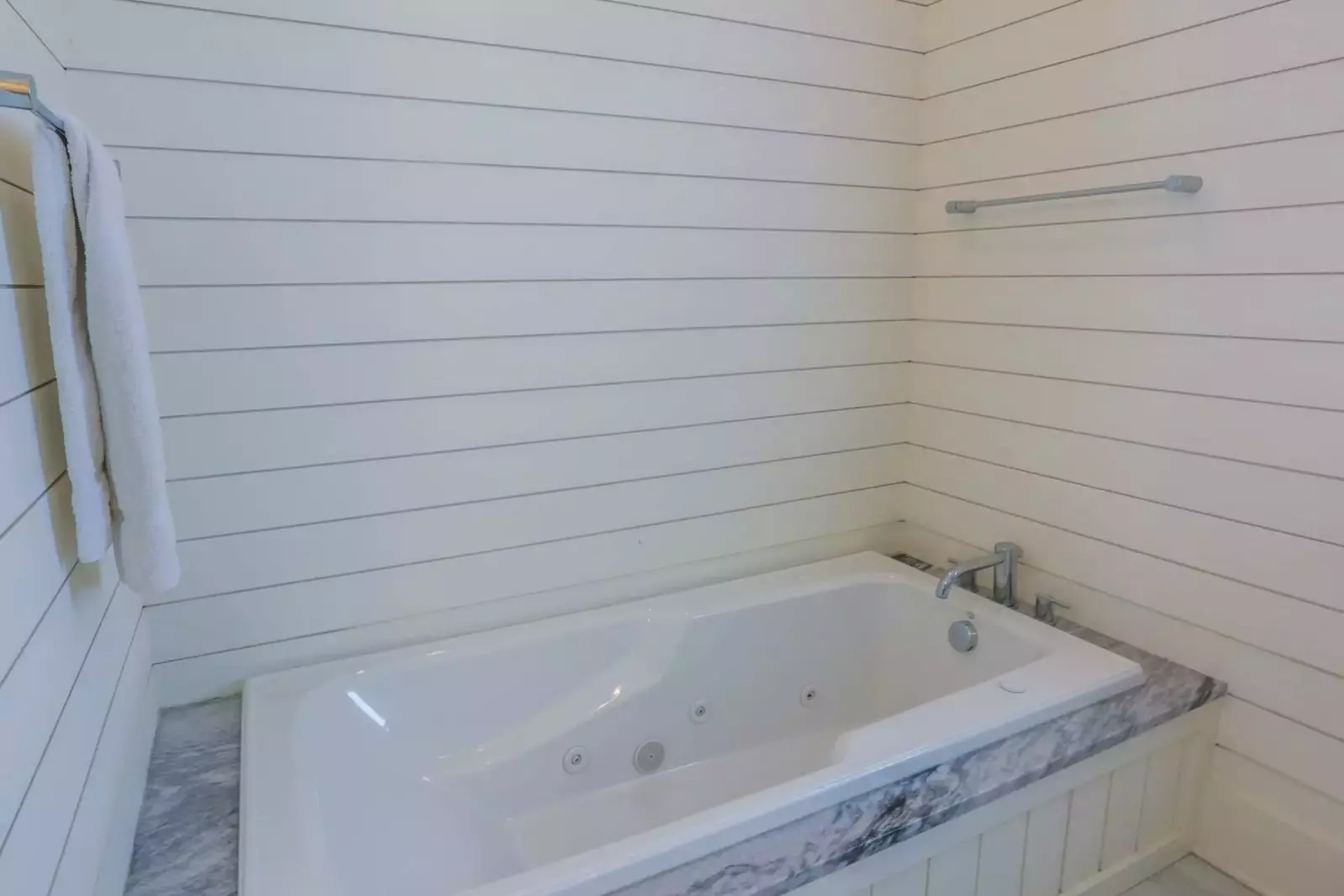 The en suite bath features a soaking tub.