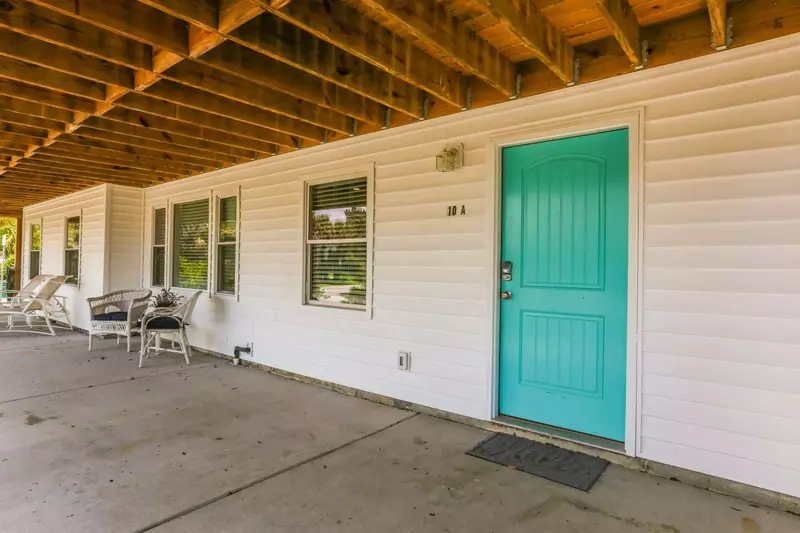 The turquoise front door leads to Carolina Breezes East!