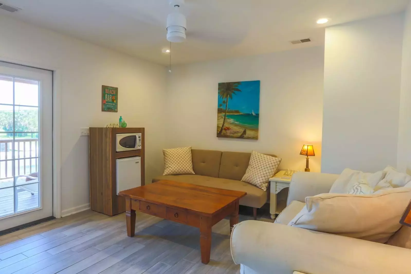 The second floor features this living room with French door access to the covered front porch.
