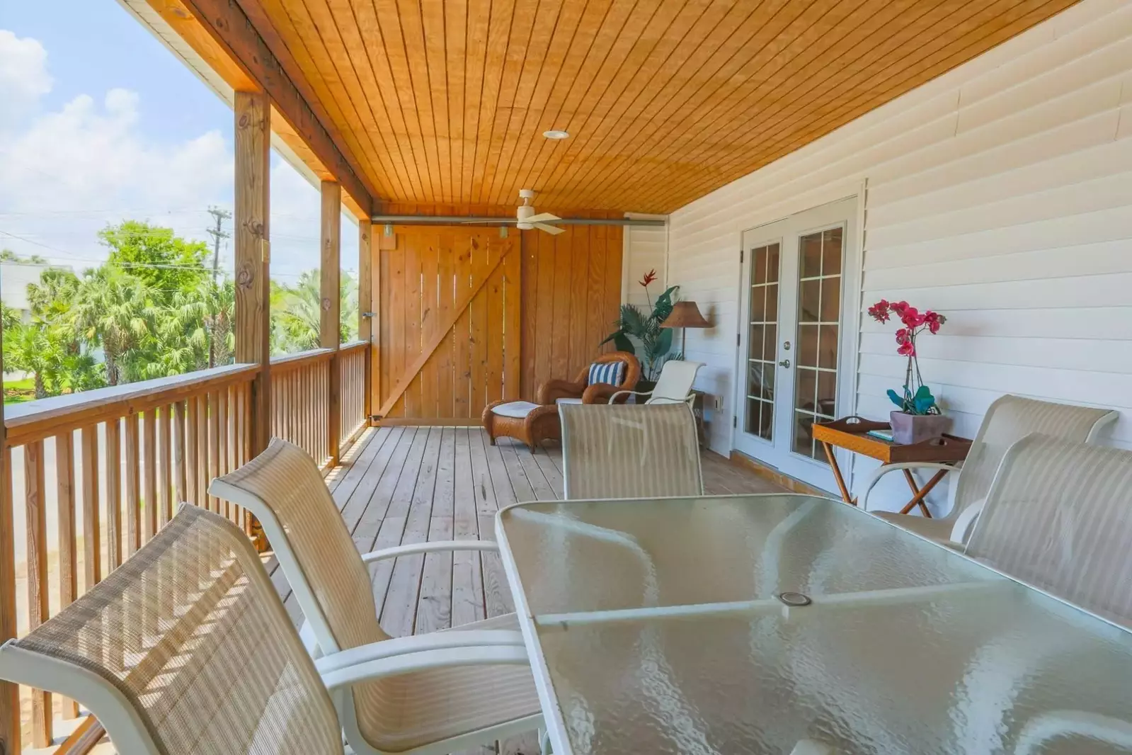 The covered deck also has an outdoor dining table.