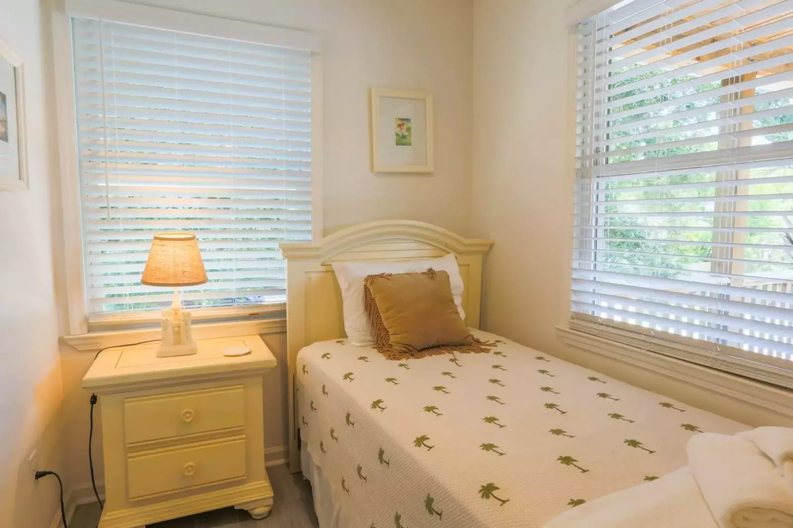 This second floor bedroom looks out onto the covered porch.