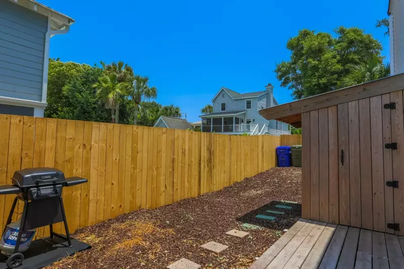 The backyard area has a propane BBQ grill and deck.