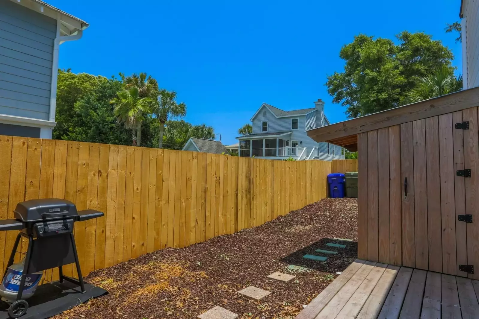 The backyard area has a propane BBQ grill and deck.