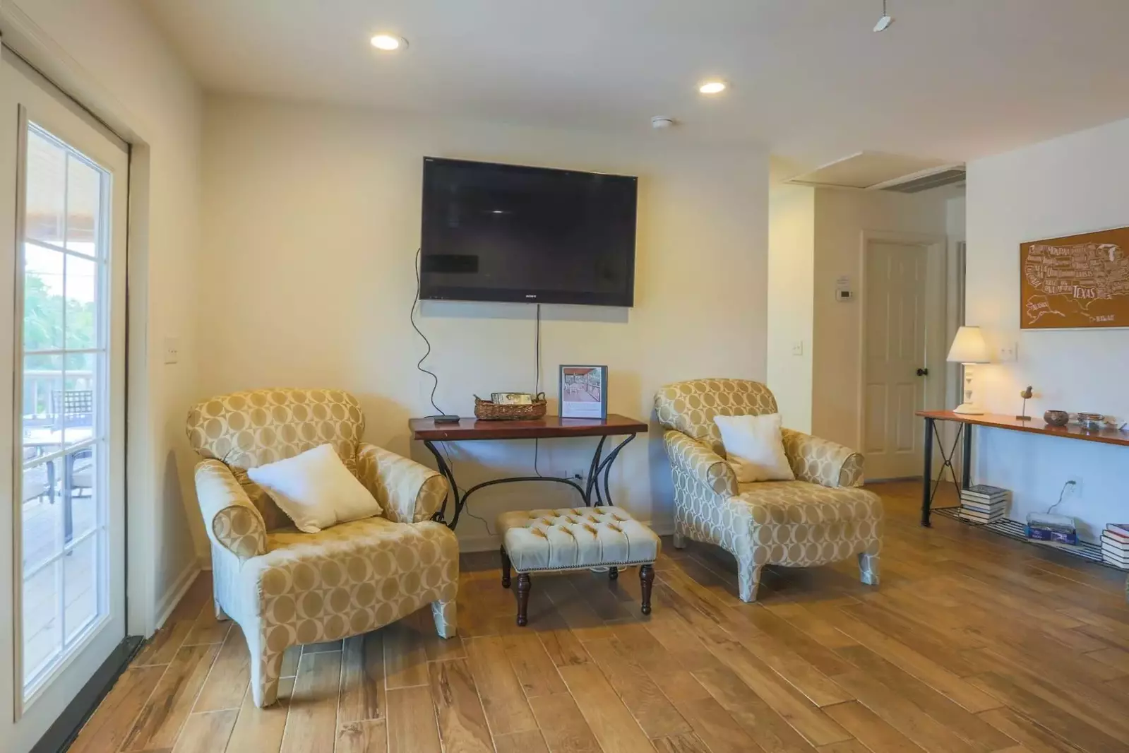 The second floor living room gets terrific natural light through the French doors that lead to the covered porch.