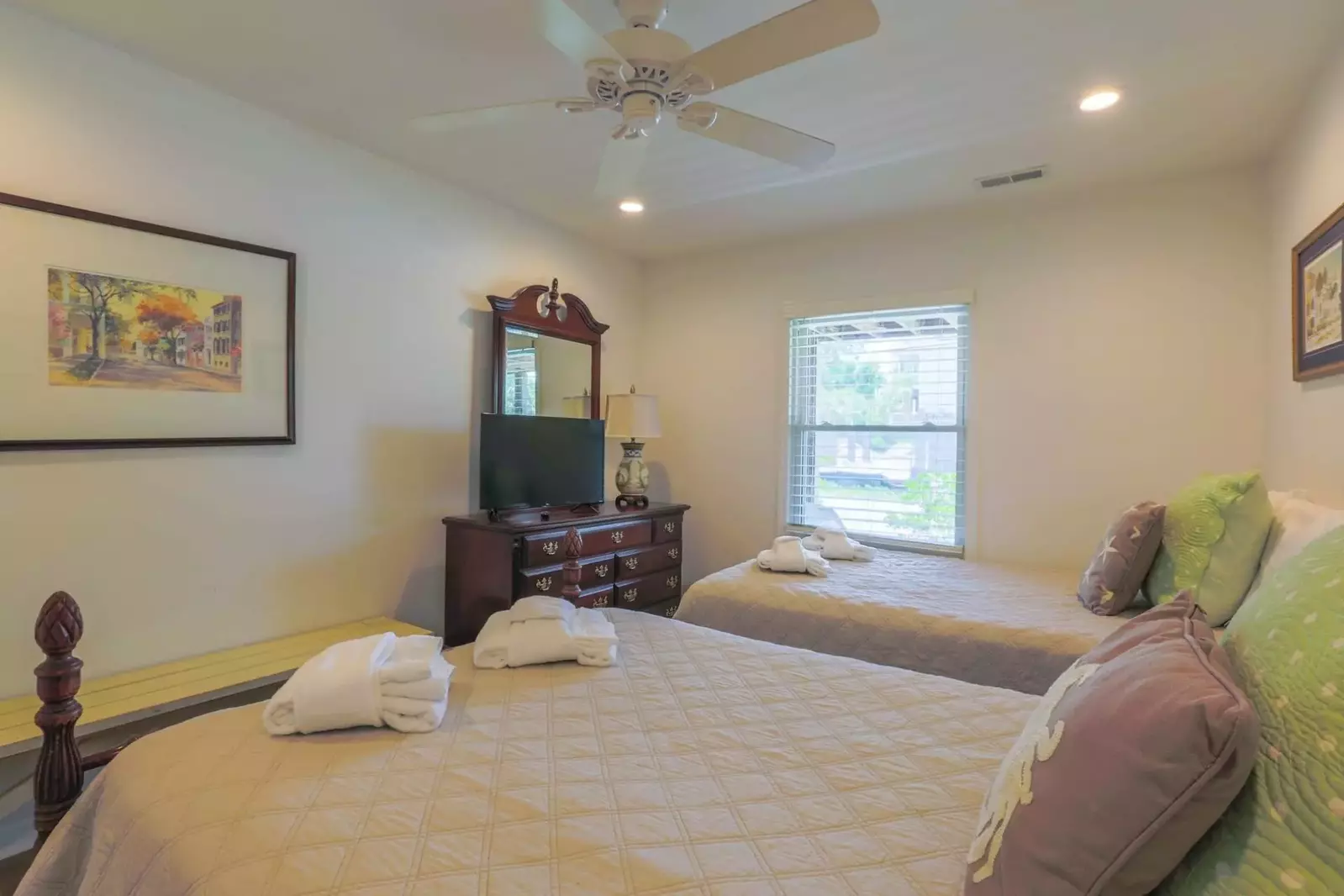 This first floor bedroom looks out onto the front covered patio.