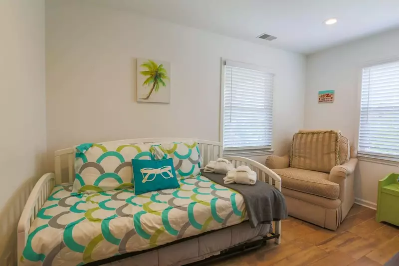 This guest bedroom features a twin day bed with a trundled twin bed.