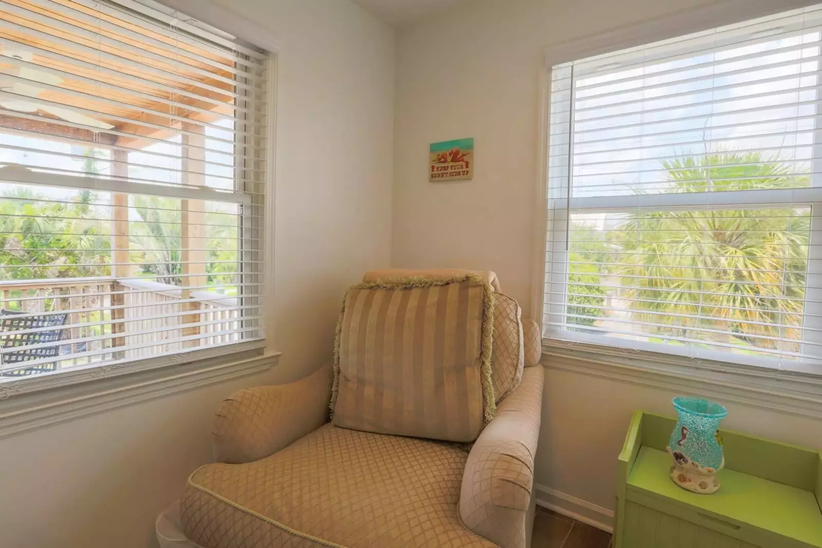 This second floor bedroom looks out onto the covered porch.