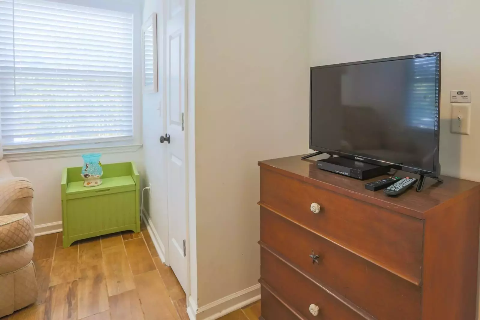 This second floor bedroom also has a dresser, smart TV and DVD player.