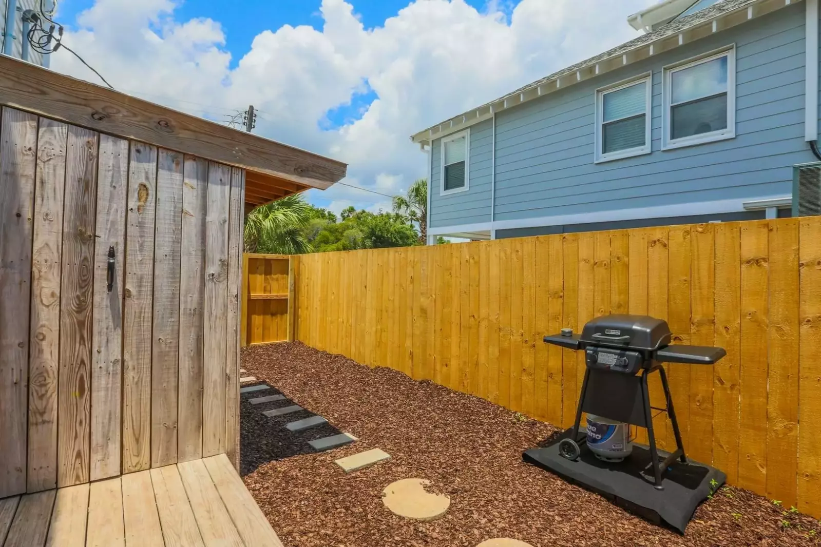 In the back yard area, you will find a propane BBQ grill and an outdoor shower.