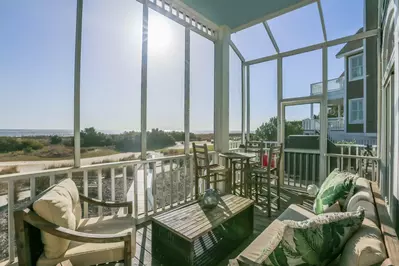 Enjoy the sights, sounds & breezes of the ocean on the home's fabulous screened porch.