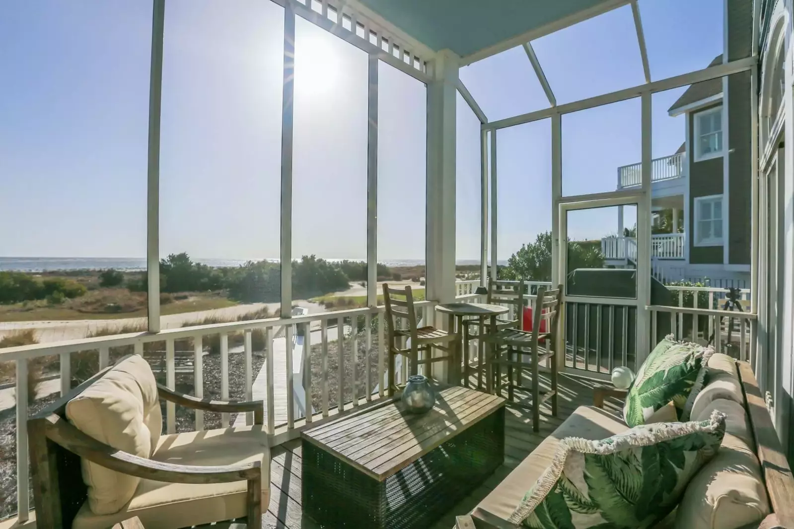 Enjoy the sights, sounds & breezes of the ocean on the home's fabulous screened porch.