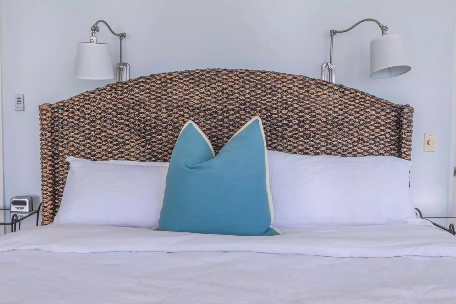 The master bedroom features a king bed with night stands & wall sconces.
