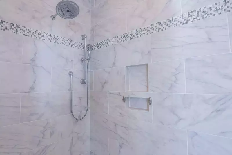 The en suite bathroom for the master bedroom has a beautifully tiled walk-in shower with a rain and hand held showerheads.