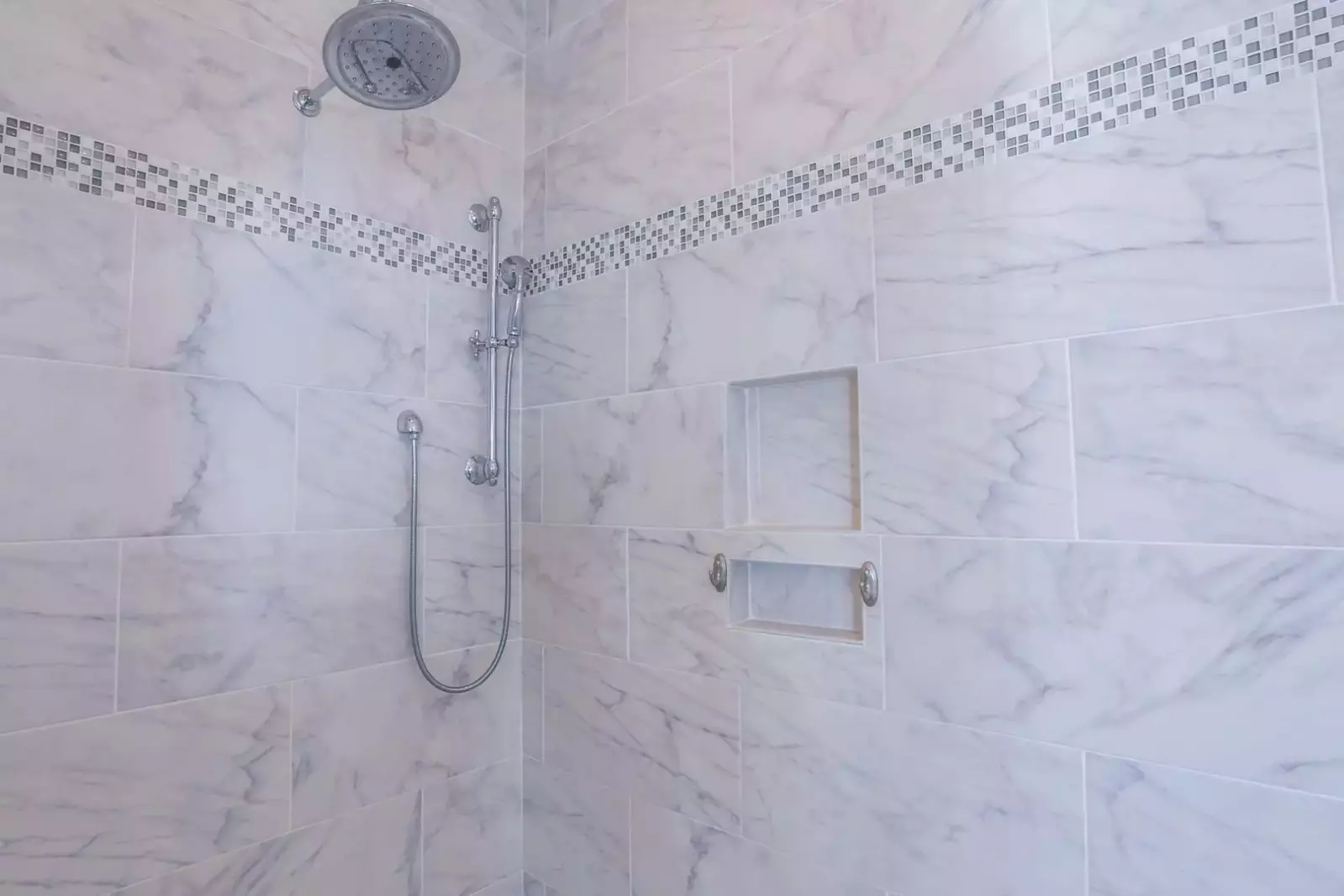 The en suite bathroom for the master bedroom has a beautifully tiled walk-in shower with a rain and hand held showerheads.