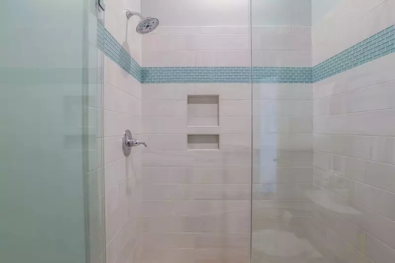 This bathroom has a beautifully tiled walk-in shower.