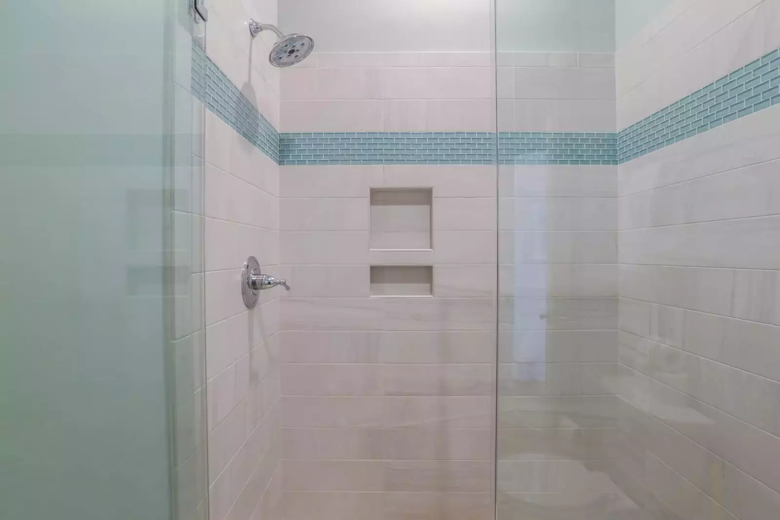 This bathroom has a beautifully tiled walk-in shower.