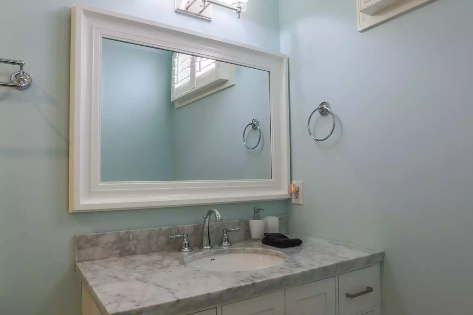 The en suite bathroom features a spacious vanity.